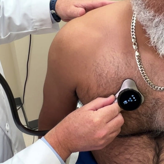 Clinician uses digital stethoscope to listen to patient's heart