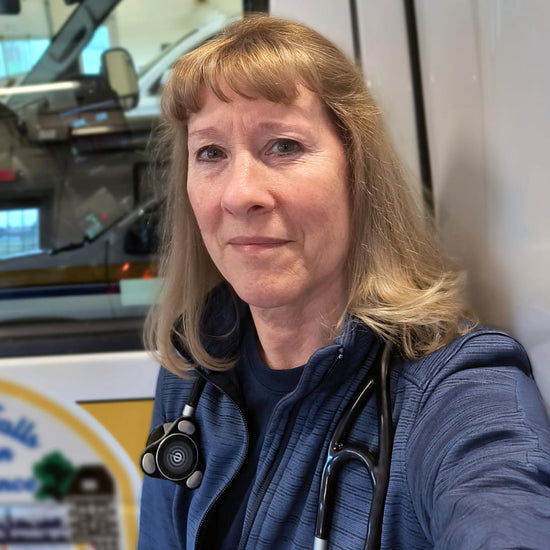 Paramedic poses outside her ambulance