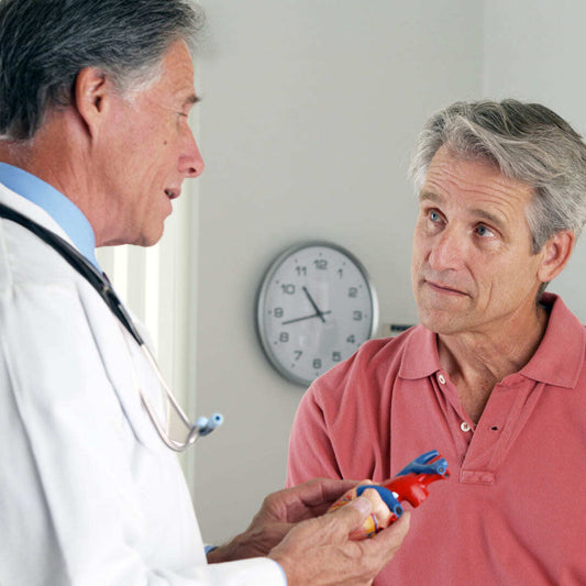 Doctor talks to patient in exam room about heart issues
