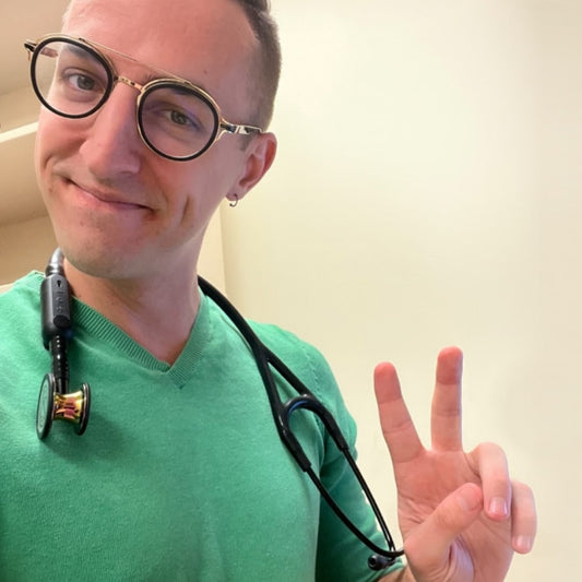 Photo of @ThatGayDoctor and a rainbow ECG line for Pride Month