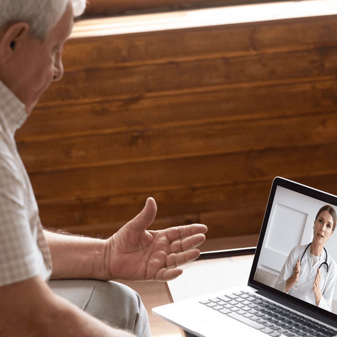 Man talking to doctor over laptop