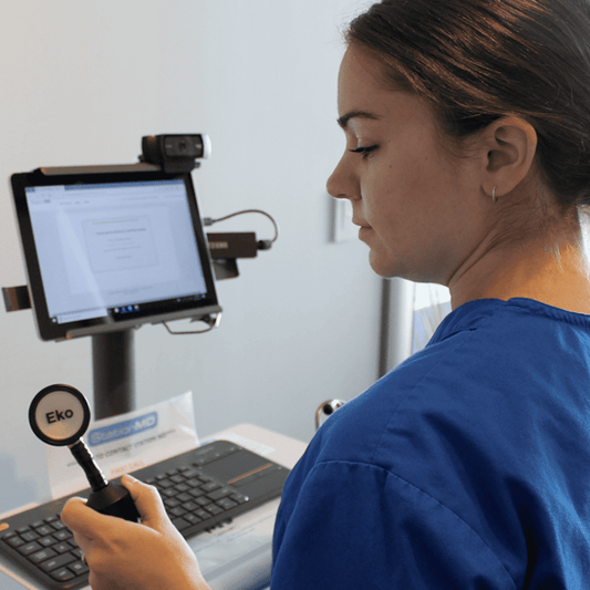 Telehealth clinician showing EKO CORE Digital stethoscope with StationMD