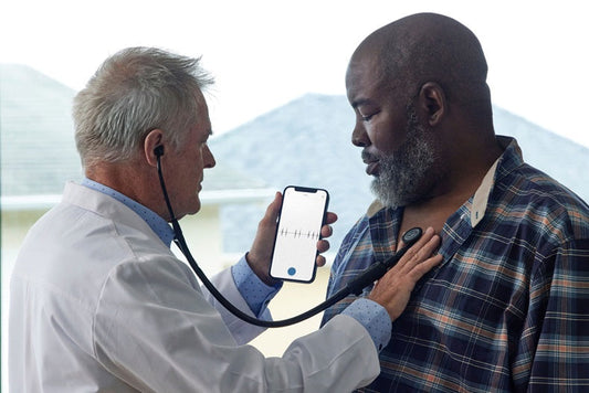 Clinician listens to patient's heart using Eko stethoscope technology and the Eko App