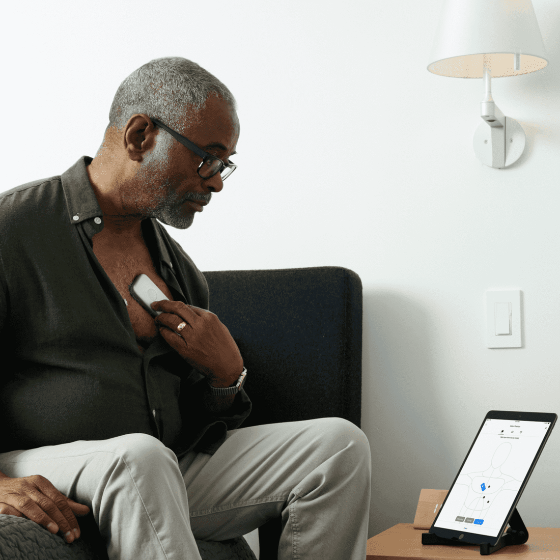 Patient using DUO 2 to record ECG and heart sounds on tablet