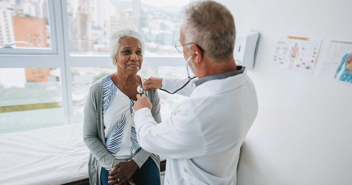 Doctor listening to patient with stethoscope